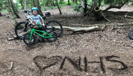 Benjamin Lower and his bike with I heart NHS message