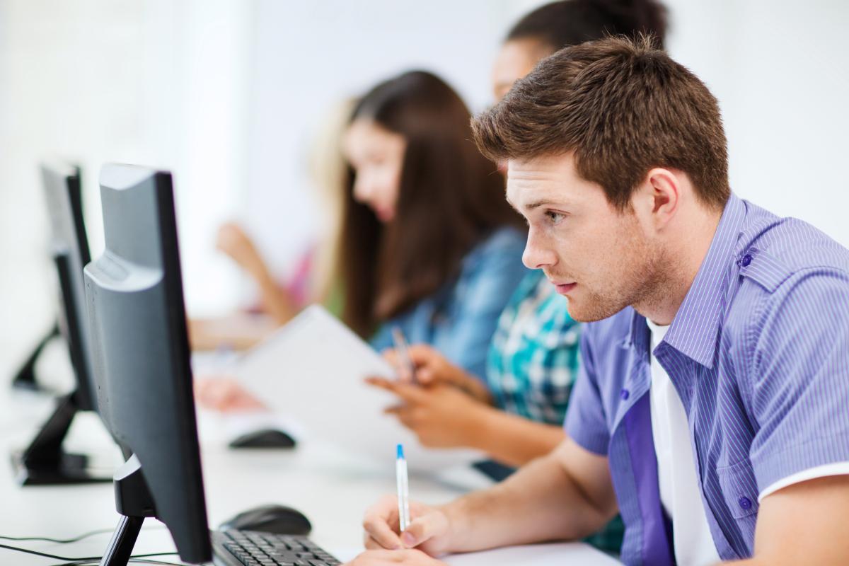 Students working in library setting on computers