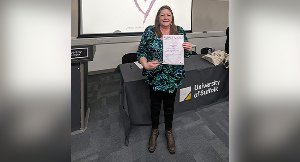 A photo of Helen Jackson holding her certificate
